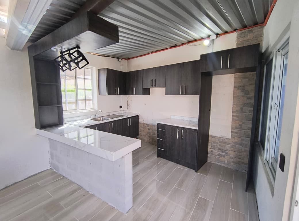 Cocina oscura con barra blanca